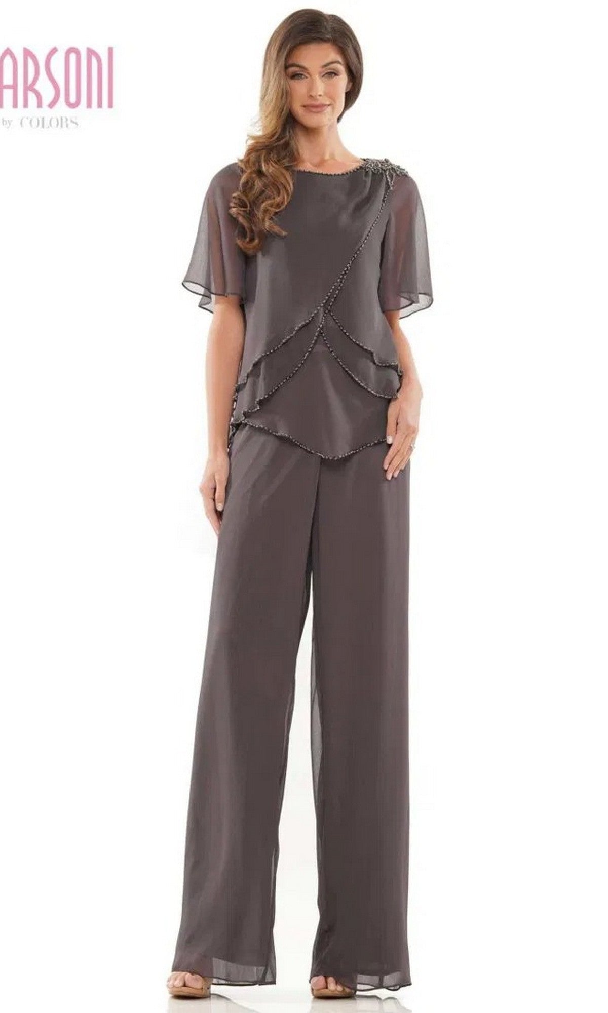 A woman wears the Marsoni M321 Long Formal Pantsuit in charcoal, featuring a loose fit and short-sleeve layered top with beaded edges.